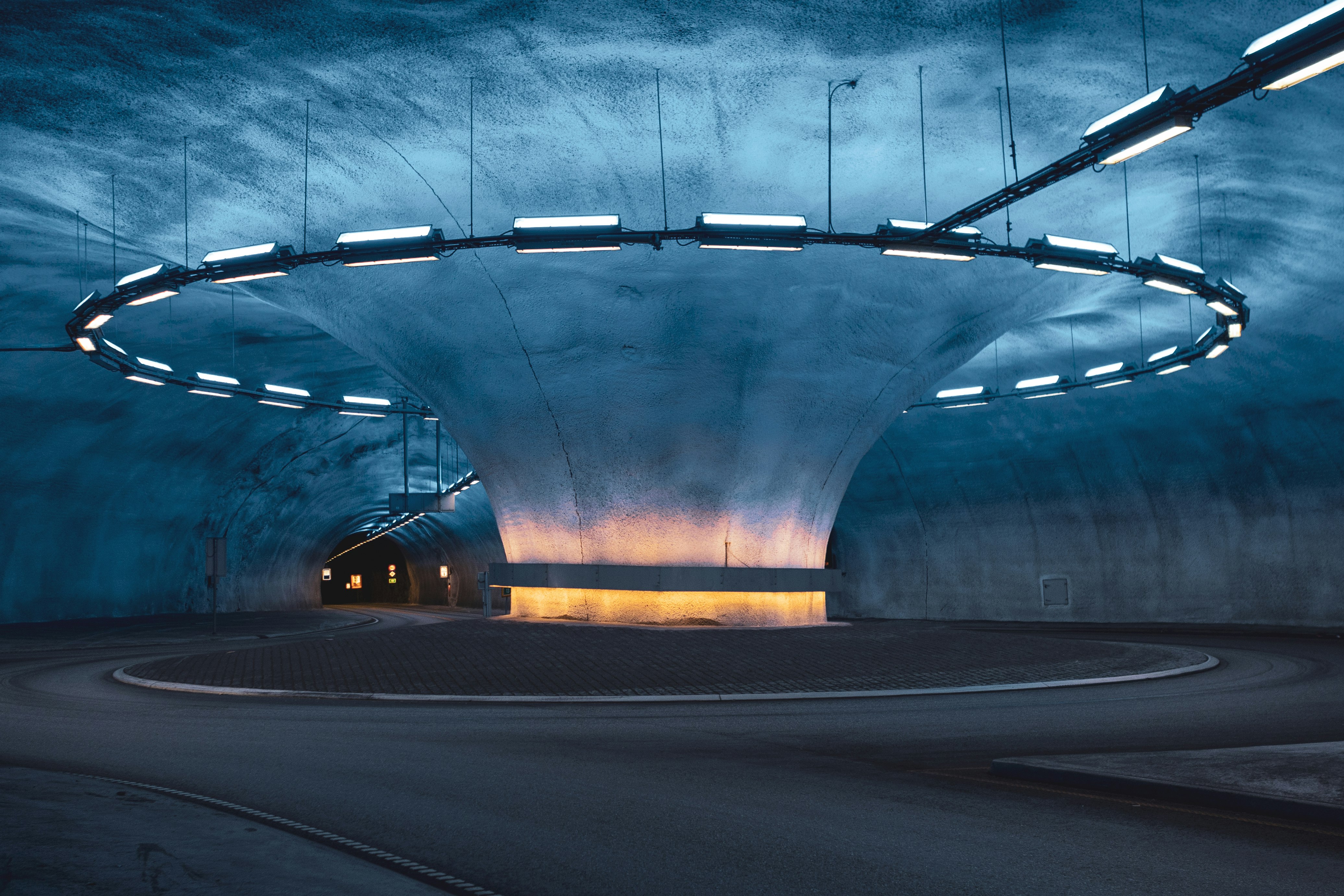 gray concrete road with yellow lights